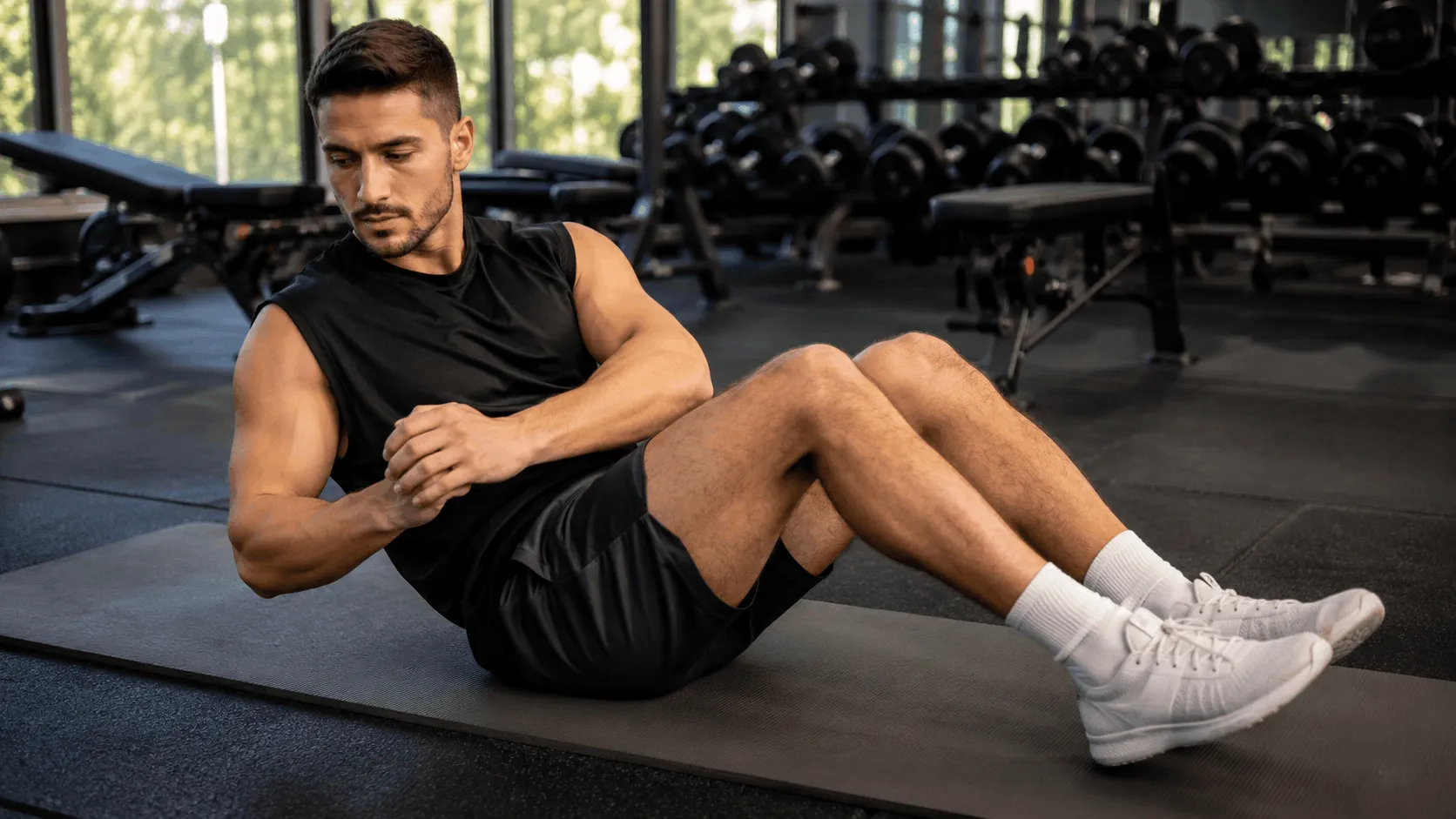 Person performing the Russian twist exercise with proper seated form